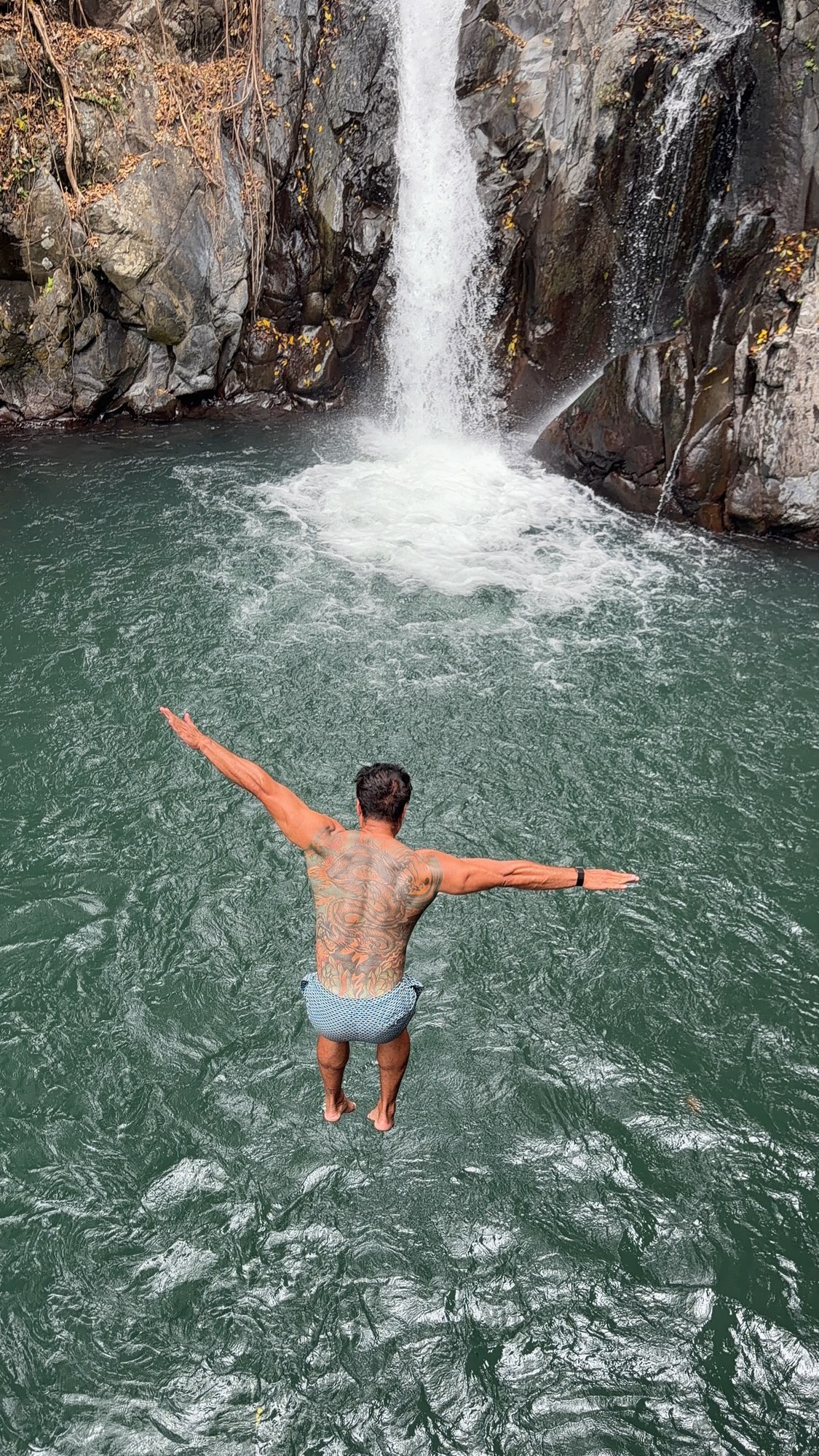 A jump into a waterfall and motocross in the jungle